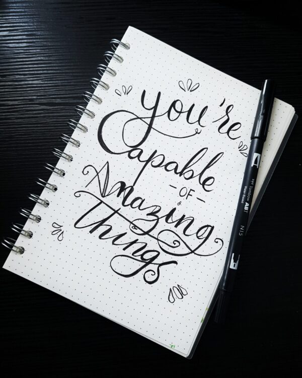 Journal saying "you're capable of amazing things" Learn about the therapy approach of Allison Holtkamp