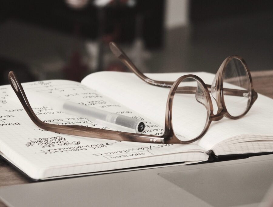 Pair of glasses on top of a journal