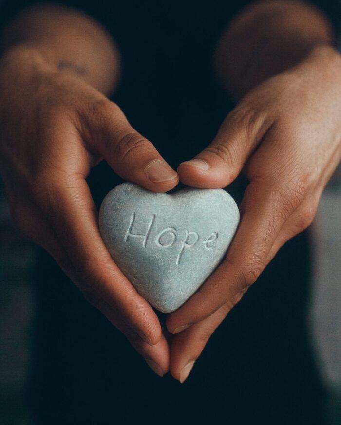 Hands holding a heart with the word hope on it. Therapy in Irvine for women